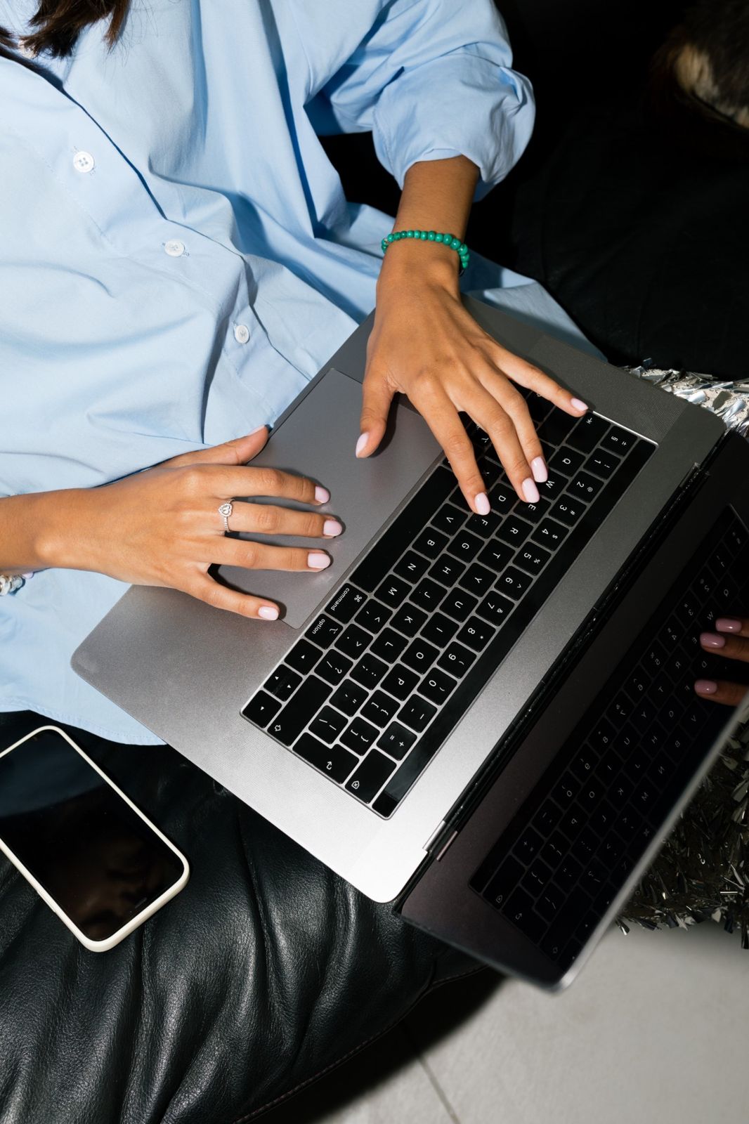 Hands typing on a laptop